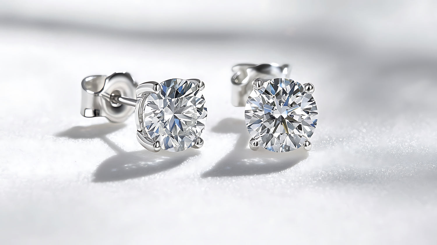 Pair of diamond stud earrings on a white background