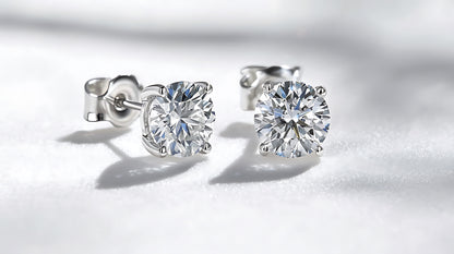 Pair of diamond stud earrings on a white background